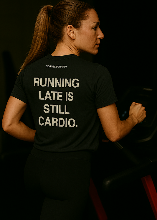 Person wearing a black t-shirt with humorous text on a dark background