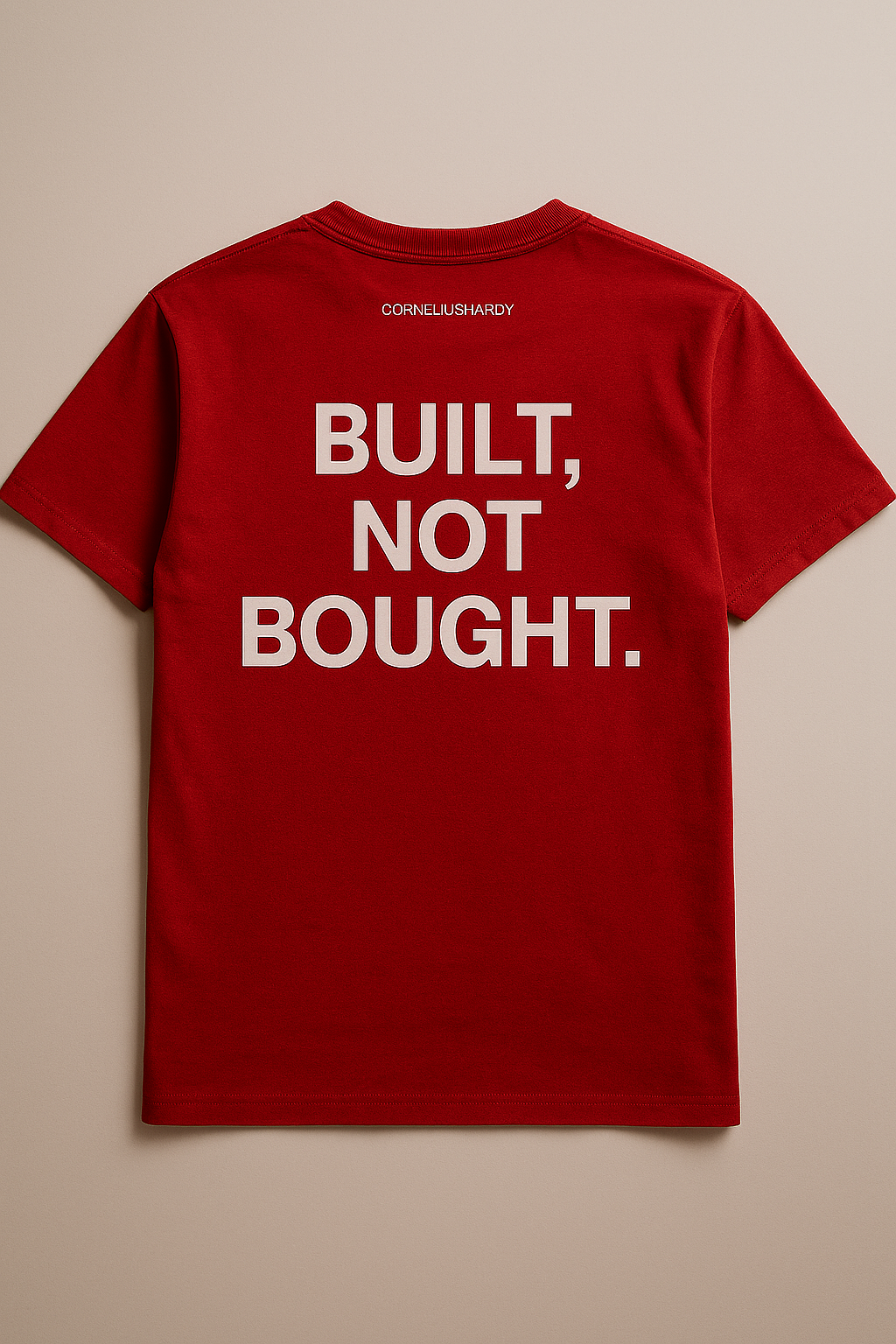 Red t-shirt with 'BUILT, NOT BOUGHT.' text on a beige background