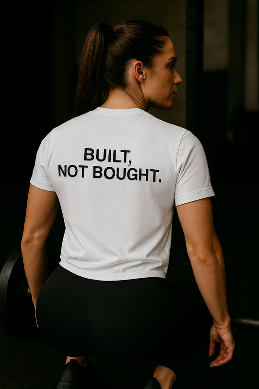 Person wearing a white t-shirt with 'BUILT, NOT BOUGHT.' text on the back.