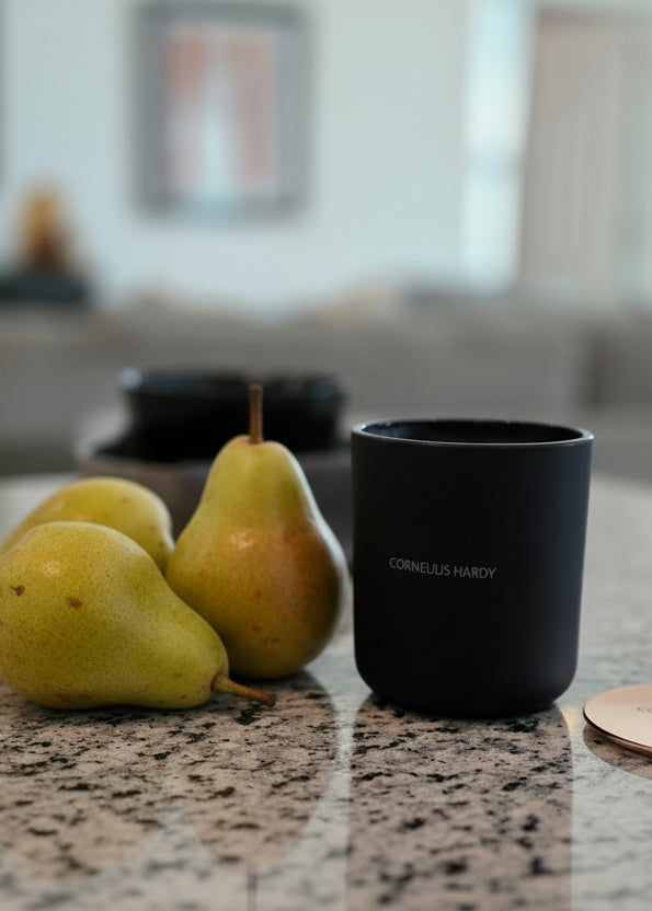 Luxury candle on a granite countertop with a blurred background