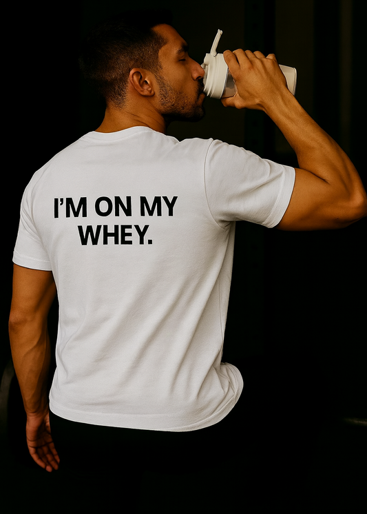 Man drinking from a container with 'I'm on my whey' text on a white t-shirt against a black background