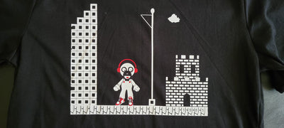 Black t-shirt with pixel art design of a character in a cityscape.